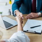 selective focus of employee and recruiter shaking hands